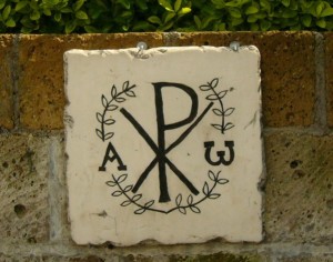 The Chi-Rho symbol, with the Greek letters Alpha and Omega represent the resurrection of Christ. Taken at the Park of Domicila catacomb in Rome, Italy. (Creative Commons)