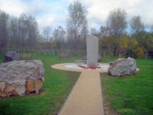 The Ulster Ash Grove's Weeping Ash trees pay tribute to those who lost their lives in the cause of peace in Northern Ireland. The pillar at the center is surrounded by stone blocks quarried from each of the six counties of Northern Ireland. (Trevor Rickard, Wikimedia Commons)