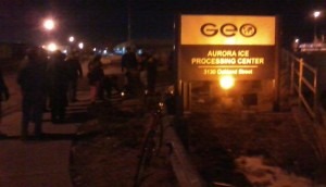 Protesters gather last night near the entrance to an Aurora, Colo.-facility that houses hundreds of immigrant detainees. (Marrton Dormish)