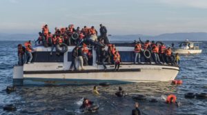 Syrian and Iraqi refugees arrive from Turkey to Skala Sykamias, Lesbos island, Greece. Spanish volunteers (life rescue team - with yellow-red clothes) help the refugees. (Ggia via Wikimedia Commons)