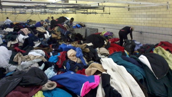 Volunteers sift through coats in one corner of Dependable Cleaners' Coats For Colorado warehouse in Denver, Colo. (Marrton Dormish)