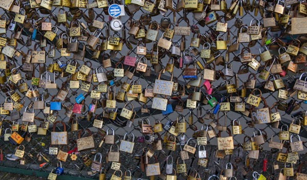 Locks placed couples as symbols of their love on the Pont des Arts bridge in Paris, France. (Frank Kovalchek via Wikimedia Commons)